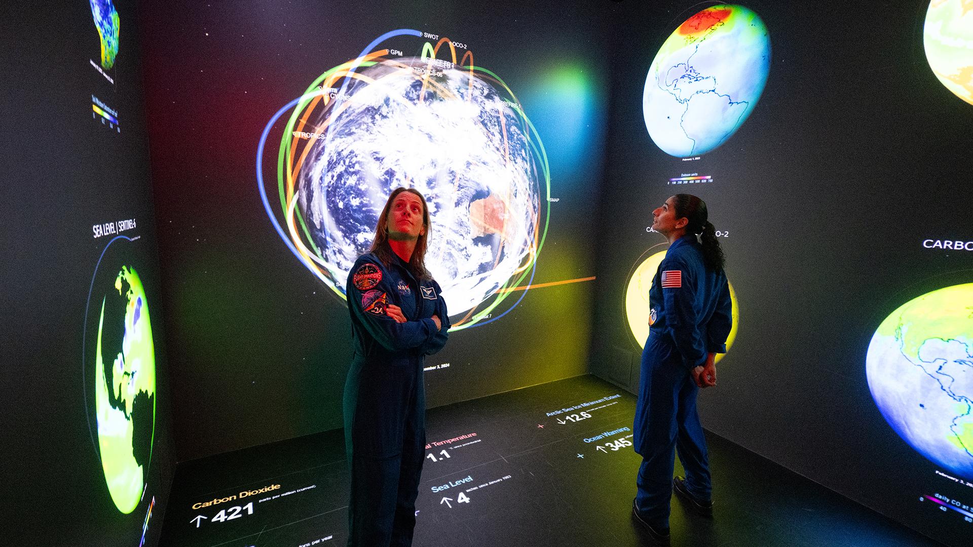 Astronauts experiencing the immersive display at NASA Headquarters.