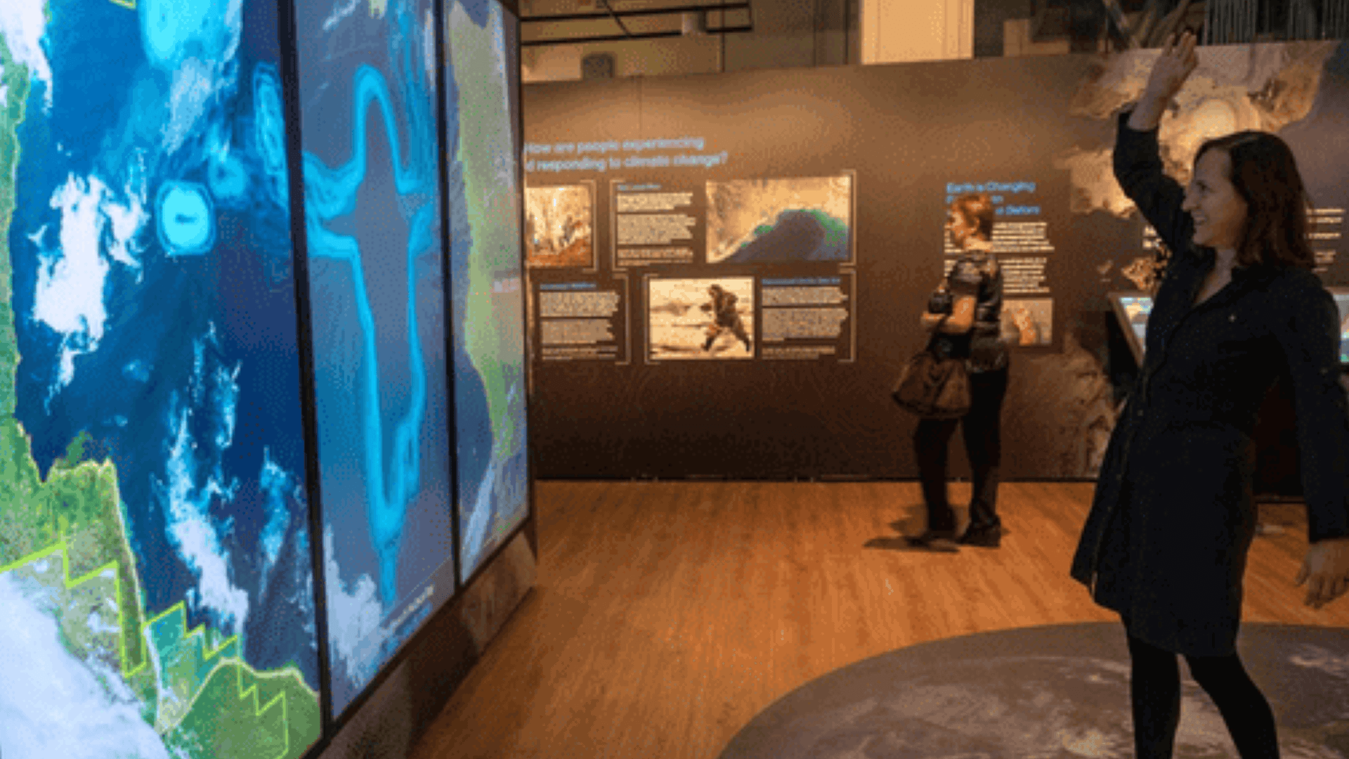 Visitors interacting with NASA's Time Unveiled exhibit at the Smithsonian National Museum of Natural History.
